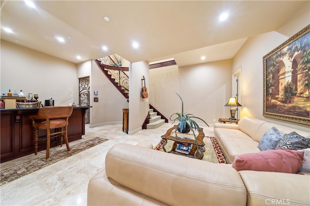 living area with marble finish floor, a dry bar, recessed lighting, and stairs