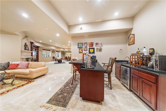 bar with visible vents, a sink, wet bar, recessed lighting, and beverage cooler