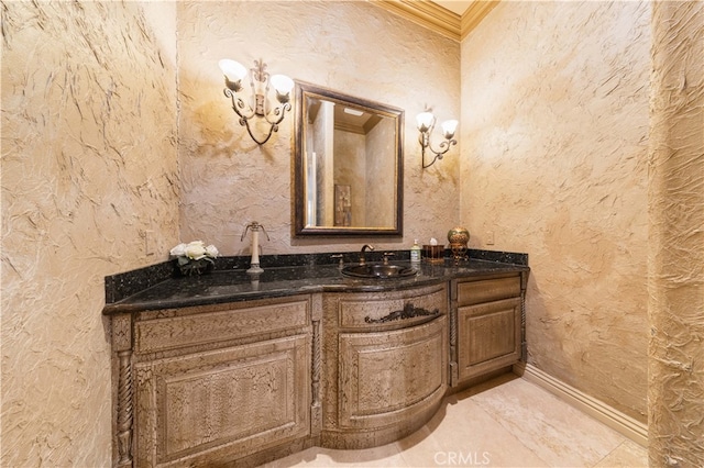 bathroom with crown molding, vanity, and a textured wall