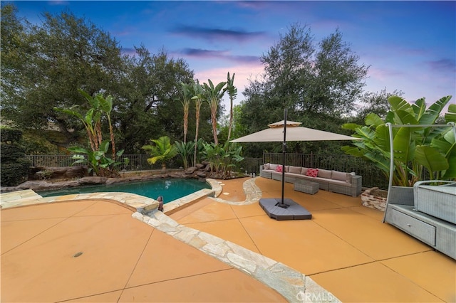 1199 Village Dr, Chino Hills, CA 91709 - pool at dusk with an outdoor living space, a patio, and a fenced backyard