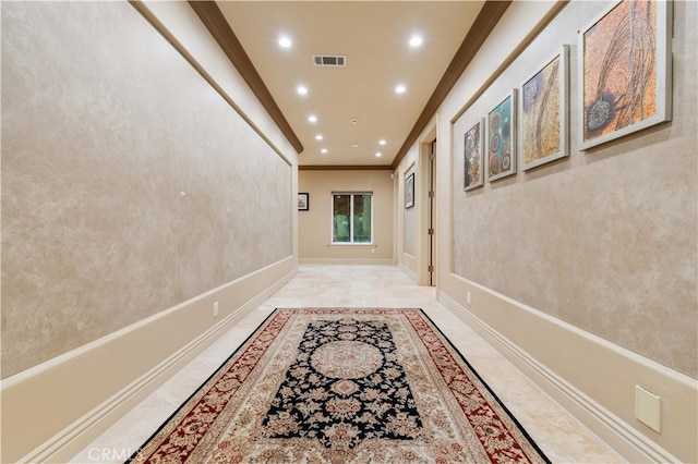 hall with recessed lighting, visible vents, baseboards, and ornamental molding