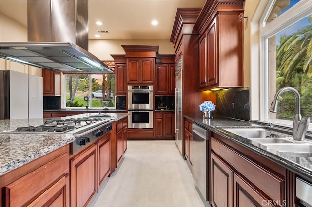 1199 Village Dr, Chino Hills, CA 91709 - kitchen with island exhaust hood, stainless steel appliances, a sink, healthy amount of natural light, and recessed lighting