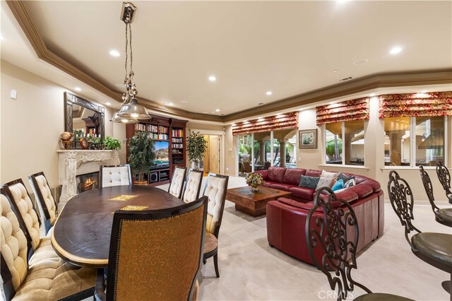 dining room featuring recessed lighting, a fireplace, and crown molding