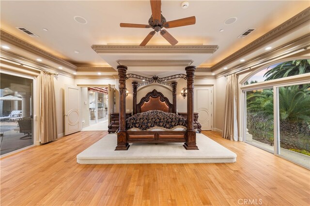 bedroom with access to exterior, wood finished floors, baseboards, and visible vents