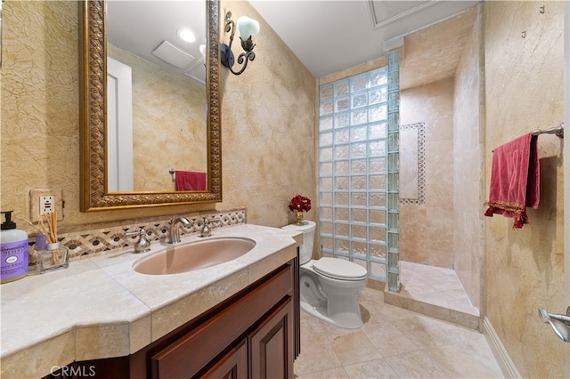 full bathroom featuring toilet, vanity, a textured wall, and walk in shower