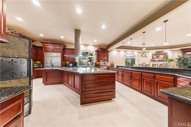kitchen featuring a sink, dark brown cabinets, stainless steel appliances, island range hood, and a large island with sink