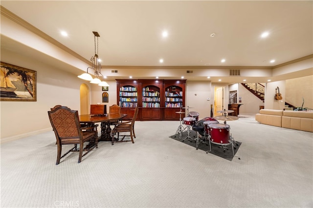 dining room featuring light carpet, arched walkways, visible vents, and crown molding