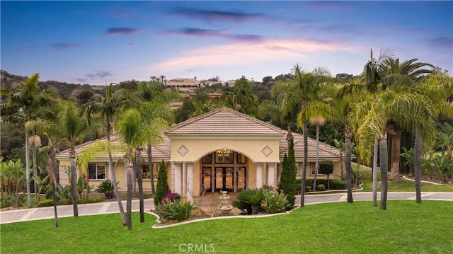 1199 Village Dr, Chino Hills, CA 91709 - mediterranean / spanish-style house with a front yard, stucco siding, and a tile roof