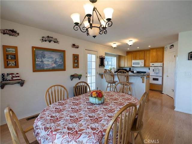406 Delle Dr, Crestline, CA 92325 - dining room featuring light wood finished floors, visible vents, baseboards, and an inviting chandelier