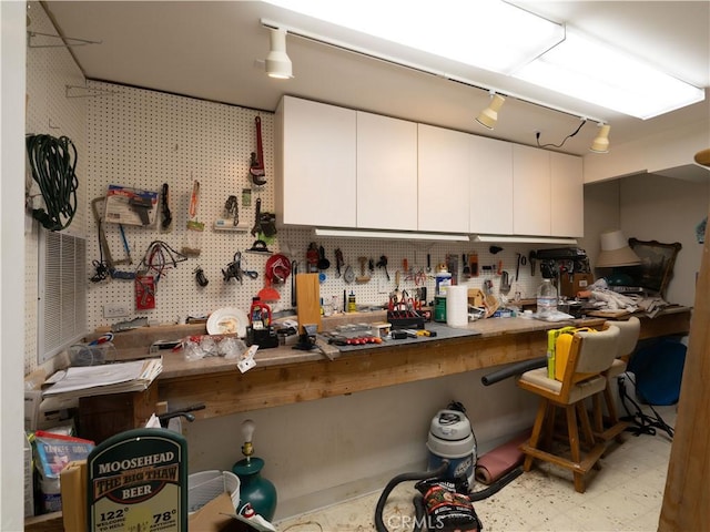 406 Delle Dr, Crestline, CA 92325 - interior space featuring tile patterned floors, rail lighting, and a workshop area