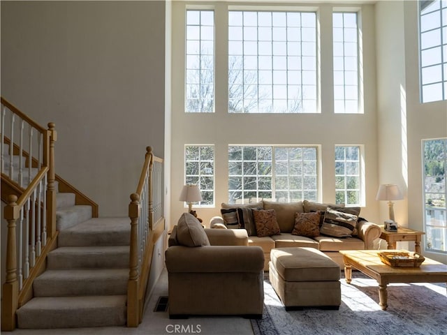 406 Delle Dr, Crestline, CA 92325 - living room with visible vents, plenty of natural light, a towering ceiling, and stairs