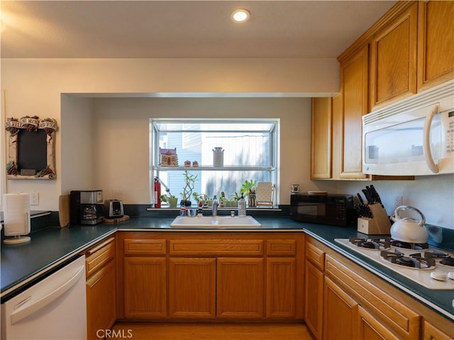 406 Delle Dr, Crestline, CA 92325 - kitchen featuring recessed lighting, white appliances, dark countertops, brown cabinets, and a sink