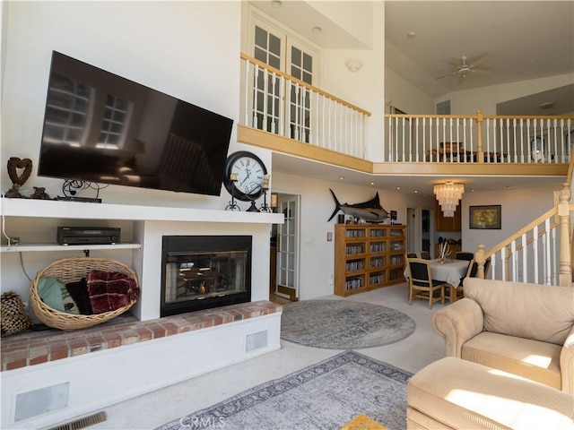 406 Delle Dr, Crestline, CA 92325 - carpeted living area with a fireplace, stairway, vaulted ceiling, and a ceiling fan