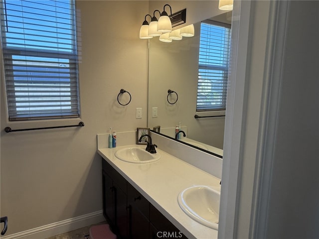 1019 El Molino Ave, Clovis, CA 93619 - bathroom featuring a sink, baseboards, and double vanity