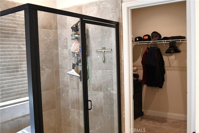 1019 El Molino Ave, Clovis, CA 93619 - bathroom featuring baseboards, a walk in closet, and a stall shower