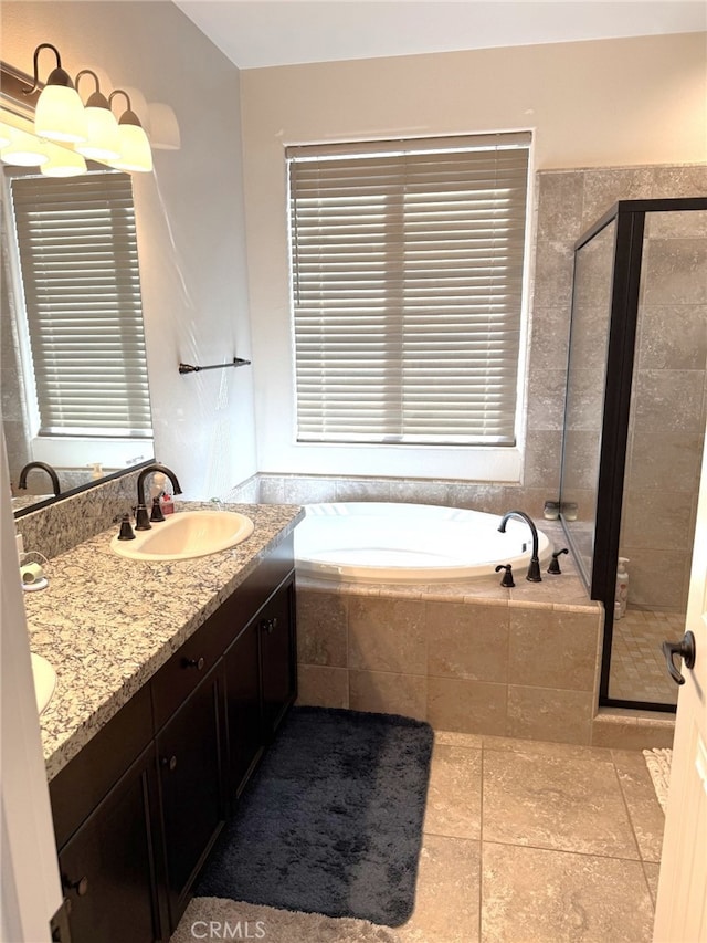 1019 El Molino Ave, Clovis, CA 93619 - full bath featuring double vanity, tile patterned flooring, a shower stall, a bath, and a sink