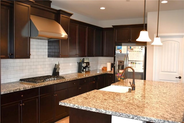 1019 El Molino Ave, Clovis, CA 93619 - kitchen featuring light stone counters, a sink, wall chimney range hood, and stainless steel appliances