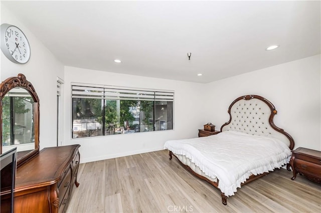 bedroom with light wood-type flooring, baseboards, and recessed lighting