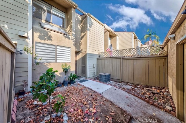 view of yard with cooling unit and fence
