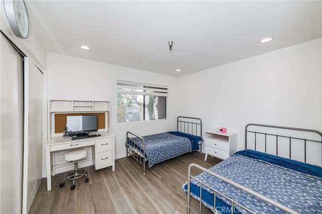 bedroom with wood finished floors and recessed lighting