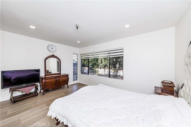 bedroom featuring recessed lighting, baseboards, and wood finished floors