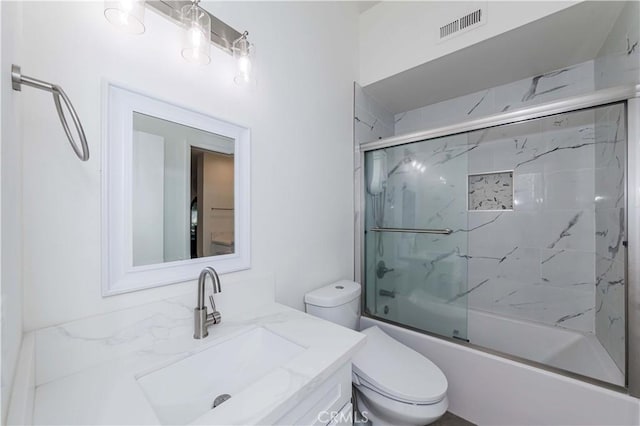 full bath with vanity, enclosed tub / shower combo, visible vents, and toilet