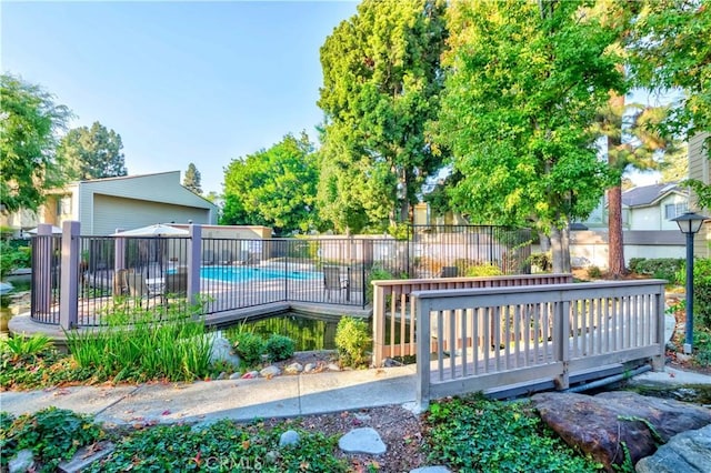view of pool with a fenced in pool, fence, and an outdoor structure