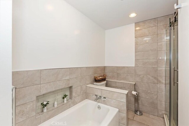 1736 E Edgecomb St, Covina, CA 91724 - full bath with a bath, a shower stall, recessed lighting, and tile walls