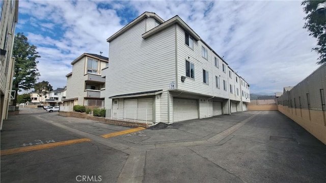 view of home's exterior with uncovered parking