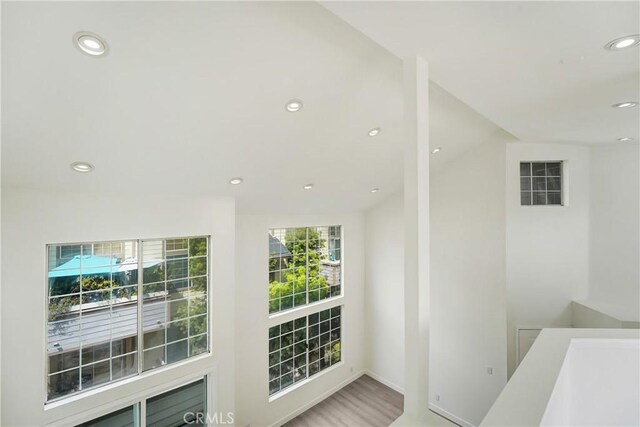 interior space featuring recessed lighting, baseboards, visible vents, and wood finished floors