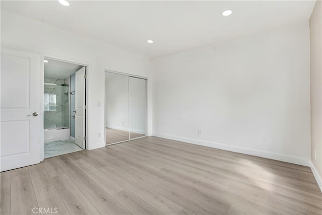 unfurnished bedroom featuring light wood-style floors and recessed lighting