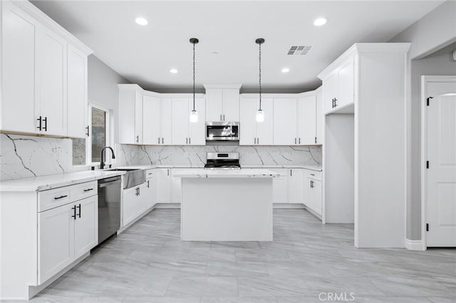 kitchen with visible vents, a center island, recessed lighting, and stainless steel appliances