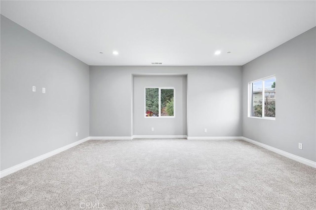 unfurnished room featuring light carpet, recessed lighting, visible vents, and baseboards