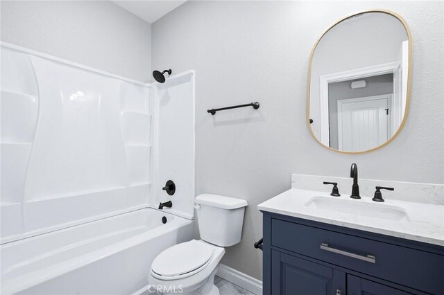 bathroom with vanity, bathtub / shower combination, baseboards, and toilet