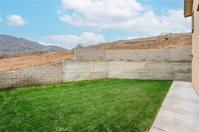 view of yard with a mountain view and fence