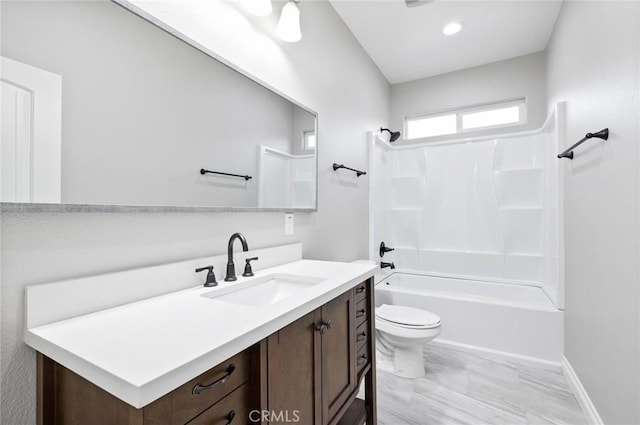 full bathroom with shower / bath combination, vanity, baseboards, and toilet