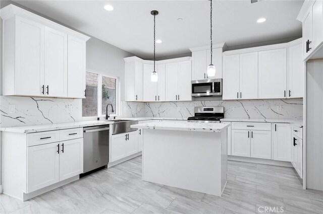 kitchen with recessed lighting, a sink, white cabinetry, and stainless steel appliances