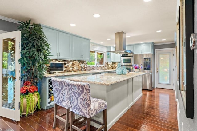 455 Ridgeview Ct, Bonita, CA 91902 - kitchen with crown molding, tasteful backsplash, dark wood-style floors, and island exhaust hood