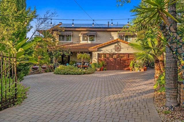 455 Ridgeview Ct, Bonita, CA 91902 - view of front of property featuring a tiled roof, roof mounted solar panels, stucco siding, decorative driveway, and a garage