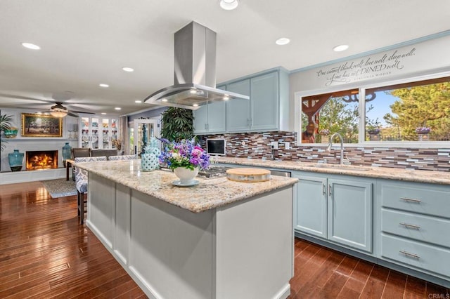 455 Ridgeview Ct, Bonita, CA 91902 - kitchen featuring a ceiling fan, recessed lighting, island exhaust hood, a sink, and backsplash