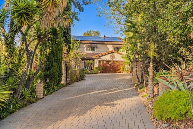 455 Ridgeview Ct, Bonita, CA 91902 - view of front of house featuring a gate, stucco siding, solar panels, and decorative driveway
