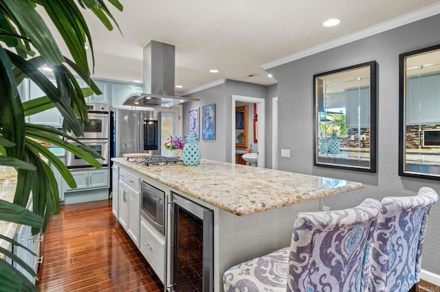 455 Ridgeview Ct, Bonita, CA 91902 - kitchen with island exhaust hood, wine cooler, crown molding, stainless steel appliances, and light stone counters