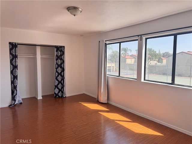 9208 Citrus Ave Unit C, Fontana, CA 92335 - unfurnished bedroom featuring dark wood-type flooring, a closet, and baseboards