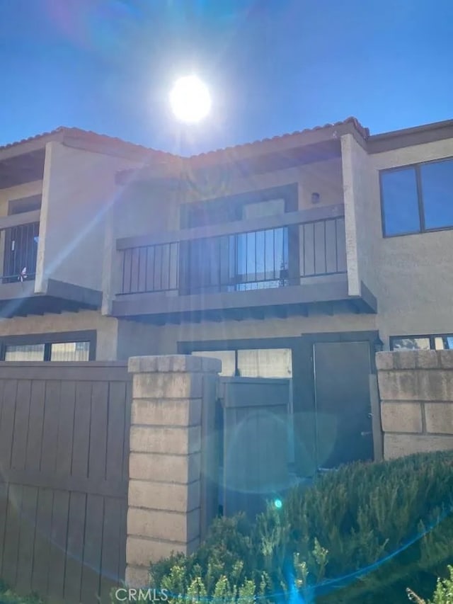 9208 Citrus Ave Unit C, Fontana, CA 92335 - townhome / multi-family property with stucco siding, fence, and a balcony