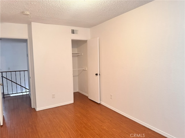 9208 Citrus Ave Unit C, Fontana, CA 92335 - unfurnished bedroom featuring wood finished floors, baseboards, and visible vents