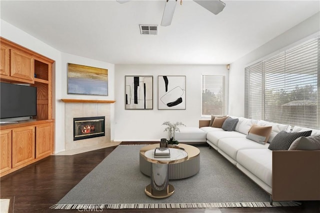 30754 Links Ct, Temecula, CA 92591 - living room with a ceiling fan, dark wood-style flooring, and a tiled fireplace