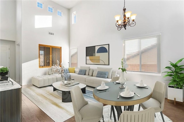 30754 Links Ct, Temecula, CA 92591 - living area with a chandelier, wood finished floors, a high ceiling, and baseboards
