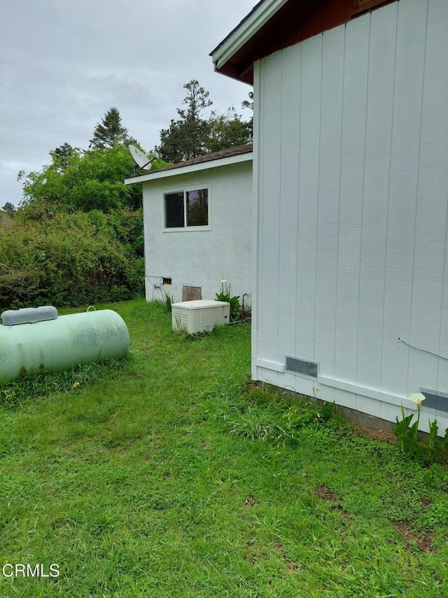 view of home's exterior with board and batten siding and a yard