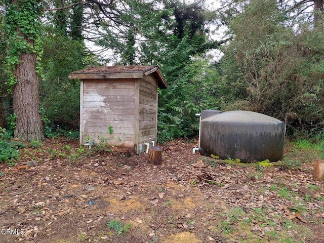 view of shed with a forest view