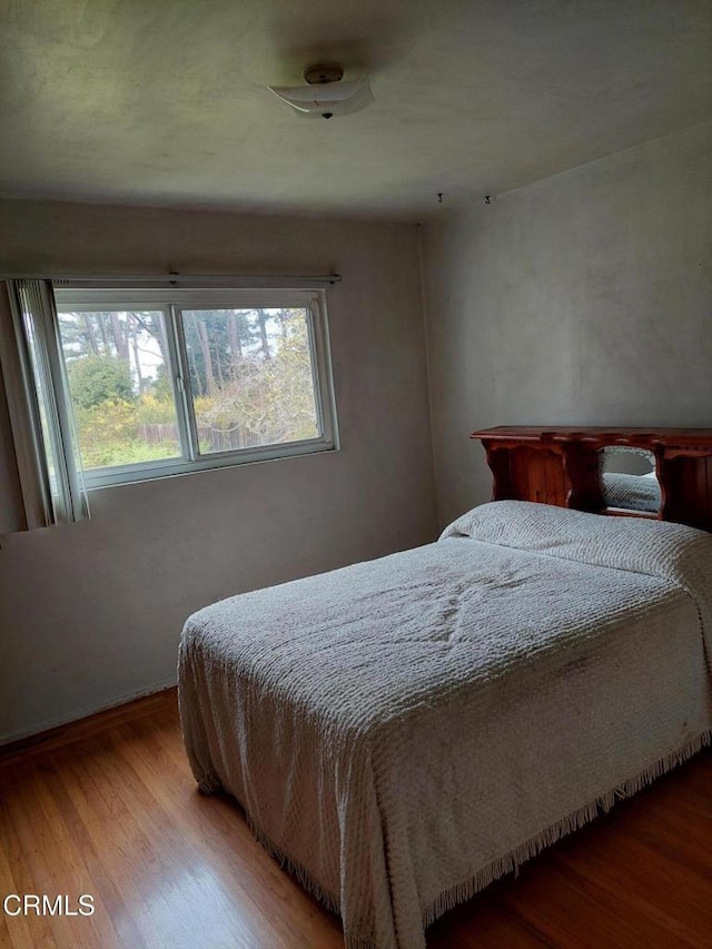 bedroom featuring wood finished floors